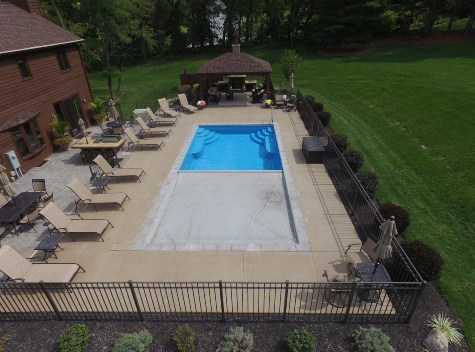 Automatic pool cover closing over an inground swimming pool