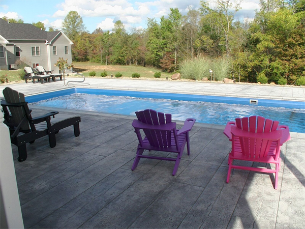 Paver pool surround blending an inground pool into a patio