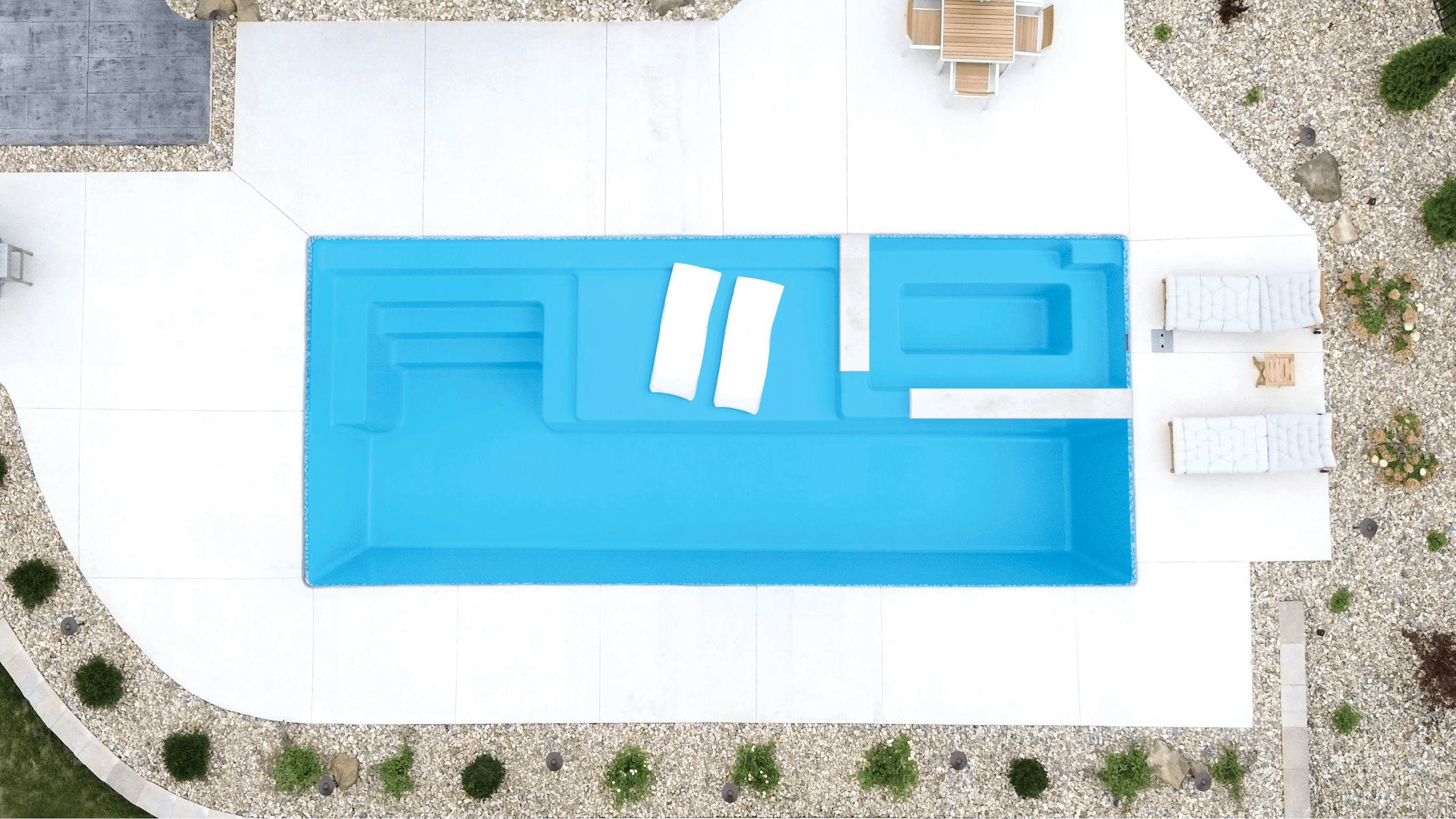 Installed Mack Daddy fiberglass pool with sun ledge and bench seating, seen from above