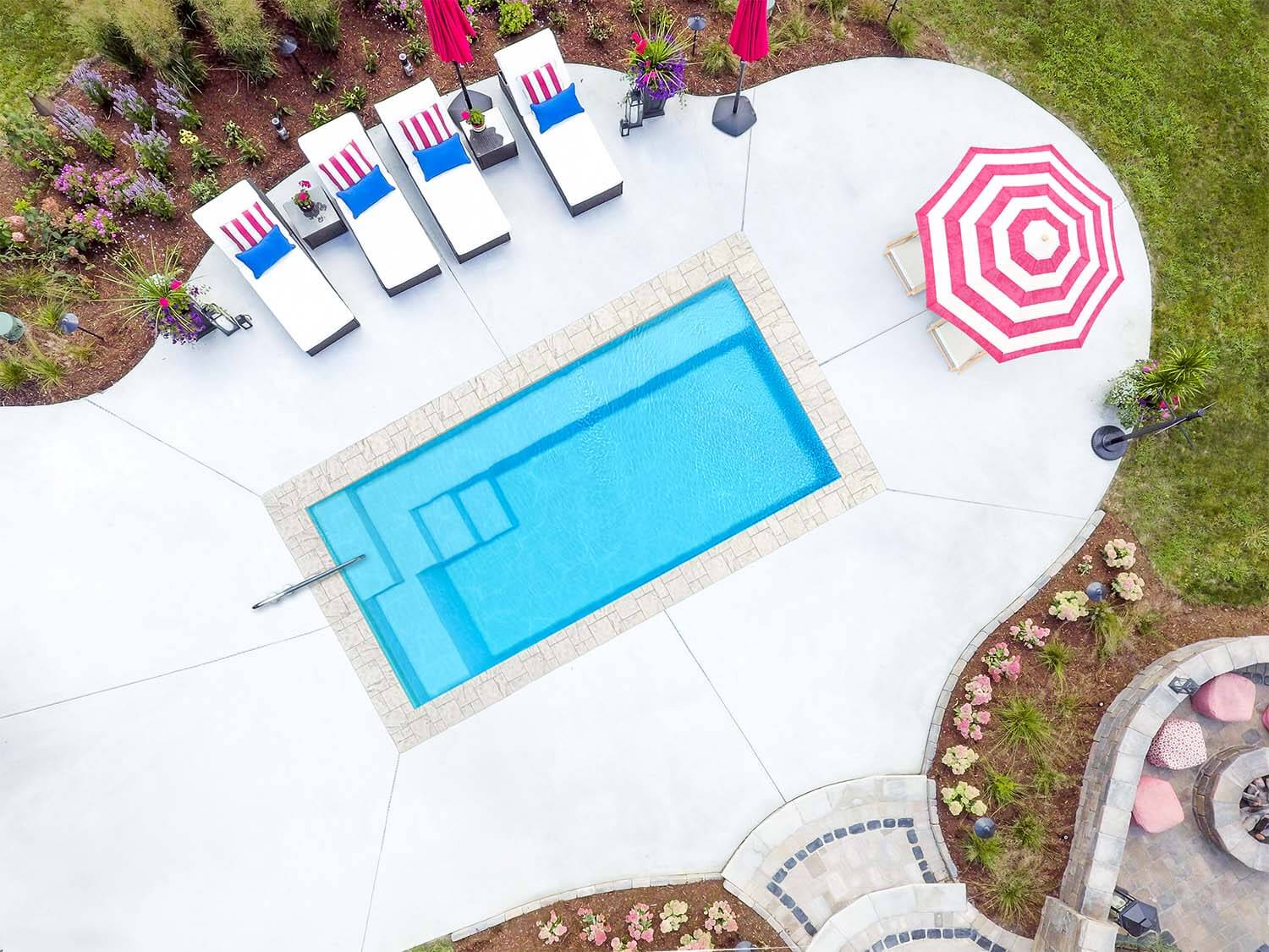 Installed The Drift plunge pool with bench seating and stone coping, seen from above