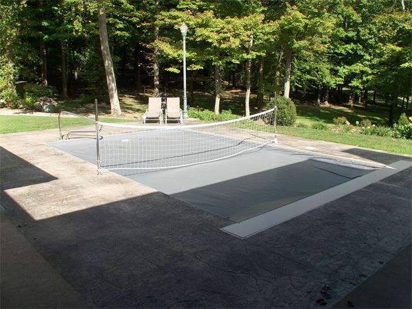 Fenced vinyl liner inground pool with patio seating area