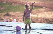 boy standing on pool cover